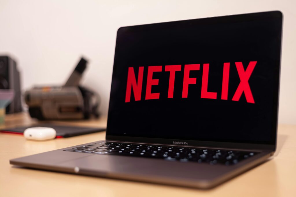 Laptop displaying the Netflix logo on screen.