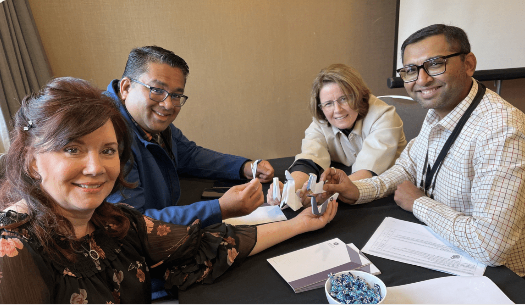 4 people sitting around a table solving problems