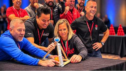 people standing infront of a table about to launch a catapult
