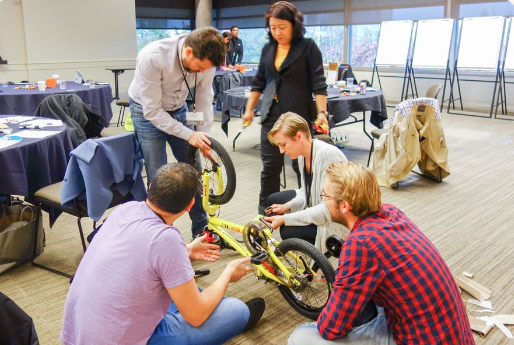 People gathering around to help build children's bikes