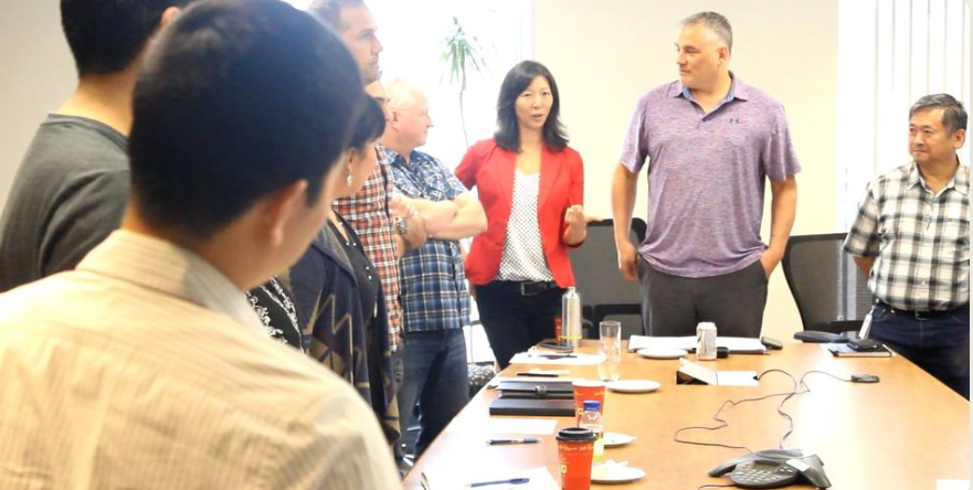 People standing around a table, learning